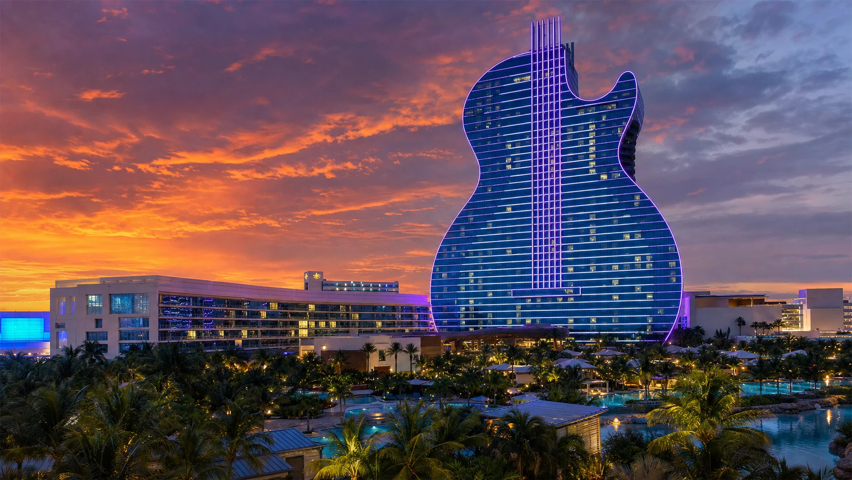 The Seminole Hard Rock Hotel and Casino guitar-shaped tower glowing at dusk in Hollywood Florida near Fort Lauderdale