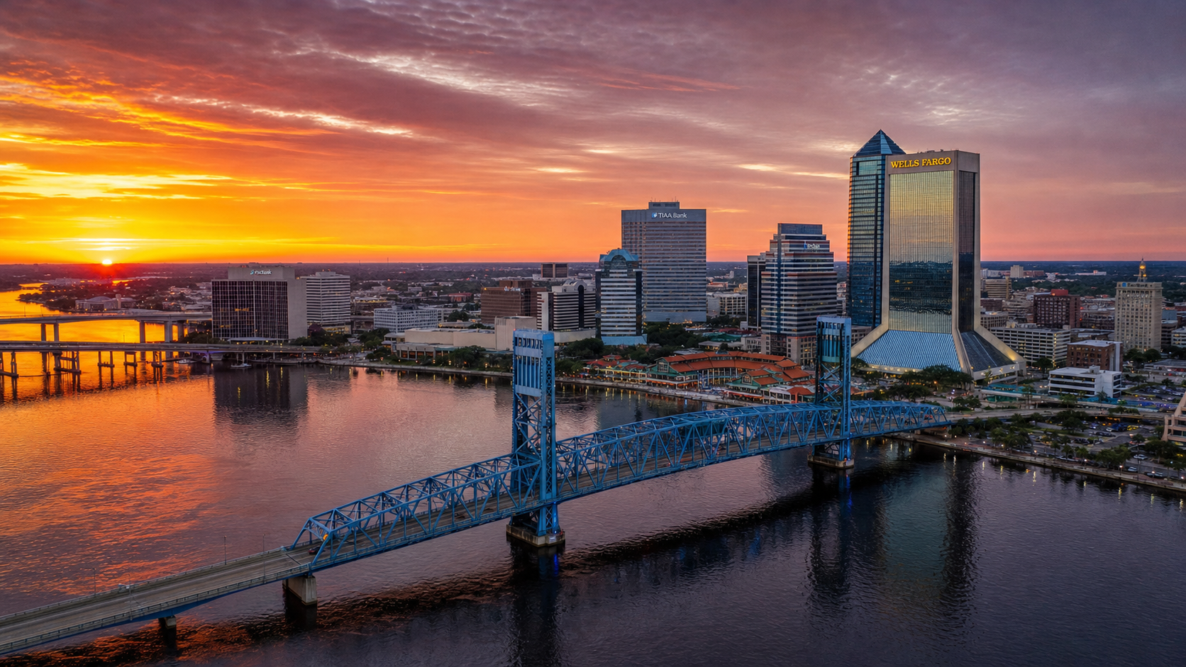 Aerial view of downtown Jacksonville Florida skyline reflected in the St. Johns River at sunset