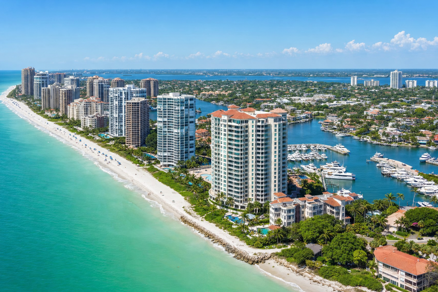 Aerial view of Naples Florida luxury waterfront condos along Gulf Coast beach with turquoise water